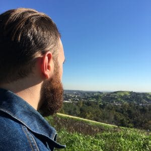 Bearded man overlooking green landscape in Los Angeles